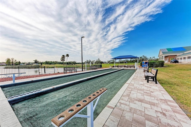 view of home's community featuring a water view and a yard