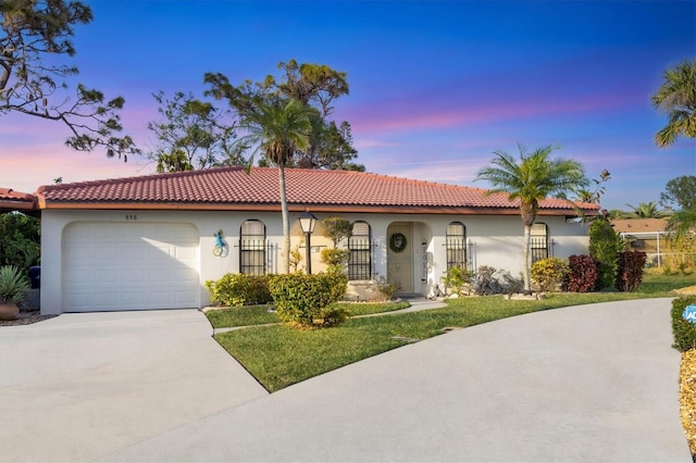 mediterranean / spanish-style house with a garage