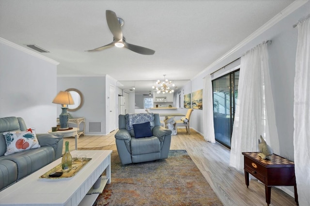 living room featuring crown molding, ceiling fan with notable chandelier, and light hardwood / wood-style floors