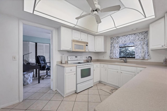 kitchen with sink, white appliances, light tile patterned floors, ceiling fan, and white cabinetry