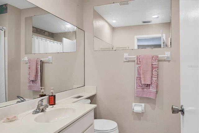 bathroom with vanity and toilet