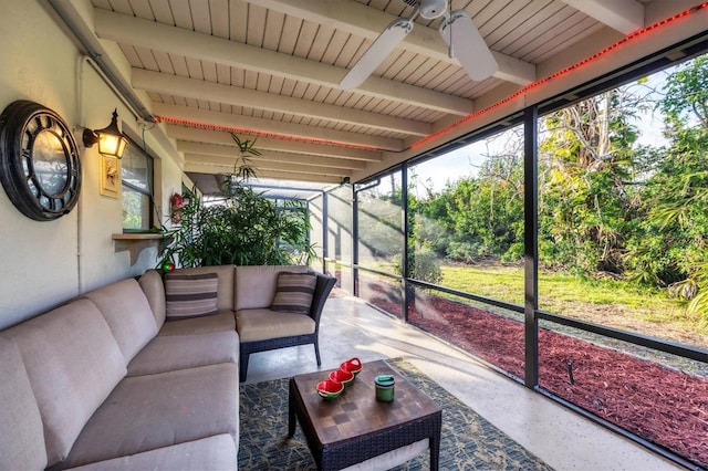 sunroom featuring ceiling fan, wooden ceiling, and beamed ceiling