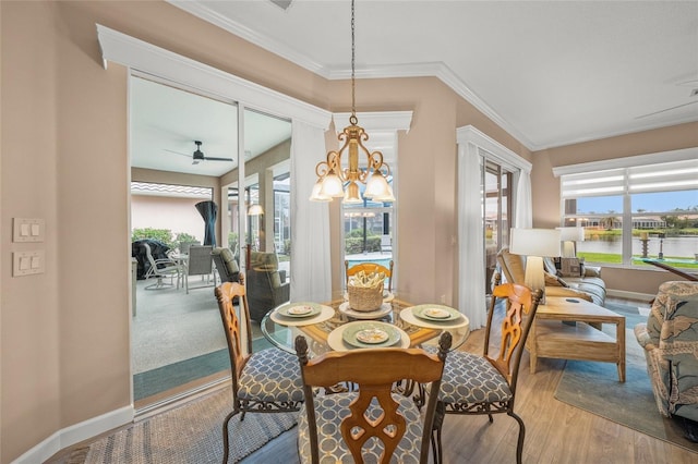 dining room featuring crown molding, ceiling fan, and hardwood / wood-style floors