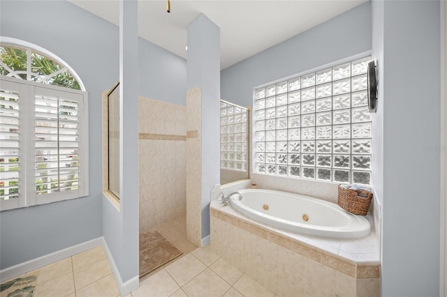 bathroom with tile patterned flooring and shower with separate bathtub