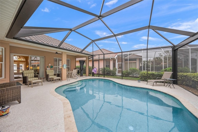 view of pool with a lanai, a patio area, and ceiling fan