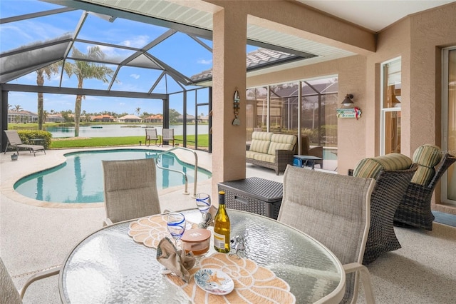 view of pool with a lanai, an outdoor hangout area, a patio, and a water view