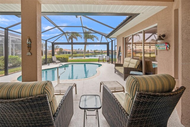 view of pool featuring a water view, an outdoor hangout area, glass enclosure, and a patio area