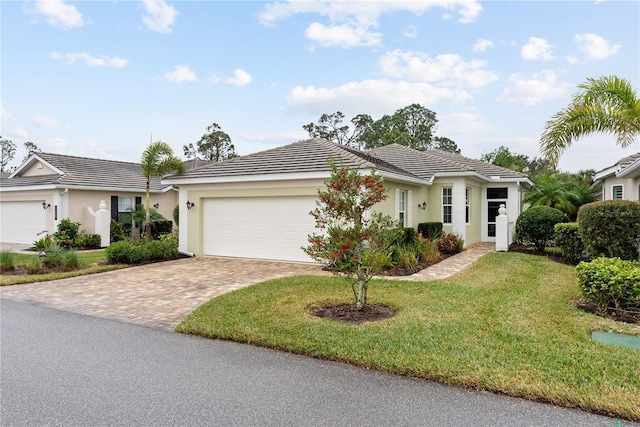 view of front facade with a garage and a front lawn