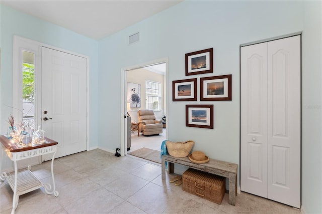 entrance foyer featuring visible vents, baseboards, and light tile patterned flooring