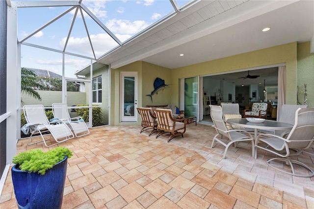 view of patio featuring glass enclosure and outdoor dining space