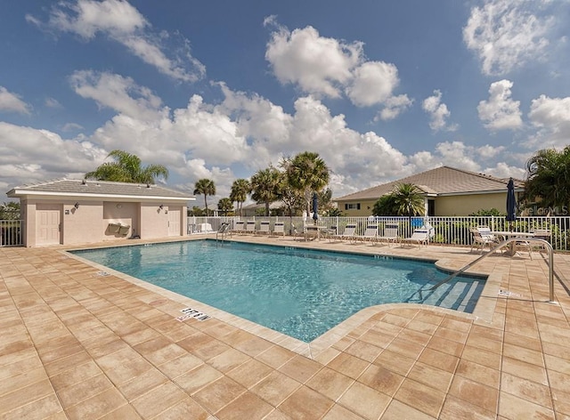 pool featuring a patio and fence