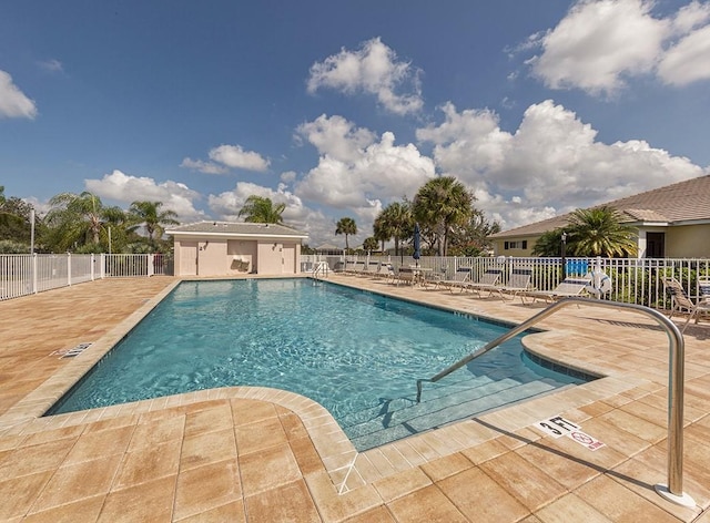 pool with fence and a patio