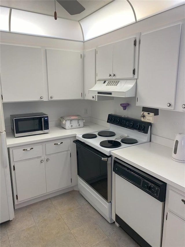 kitchen featuring white appliances, white cabinets, and light tile patterned flooring