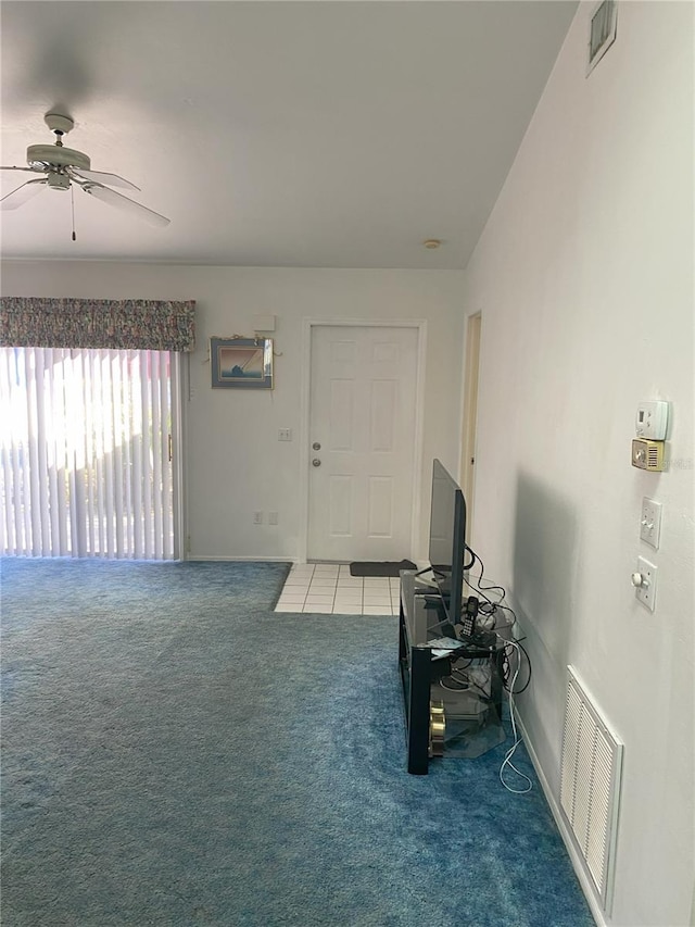 carpeted entryway featuring vaulted ceiling and ceiling fan