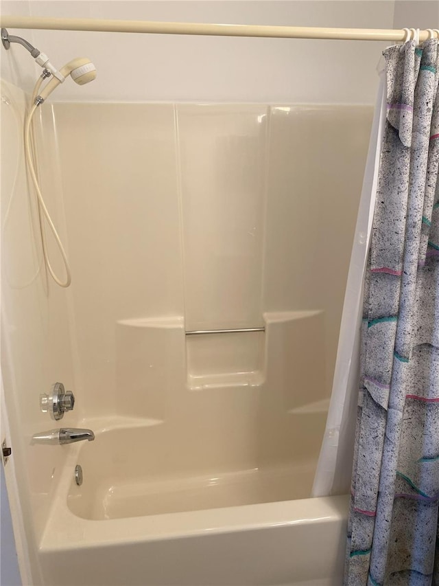 bathroom with shower / bathtub combination with curtain