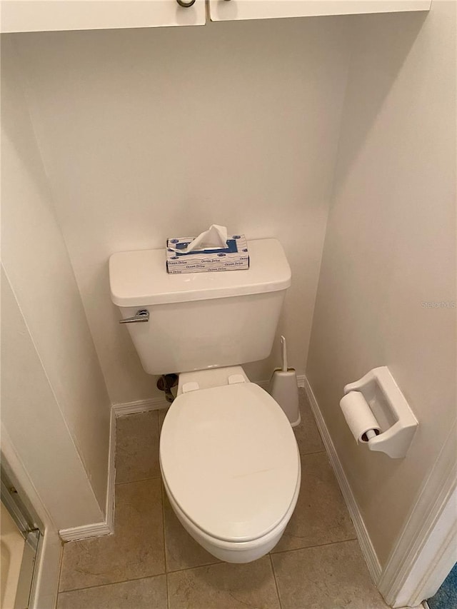 bathroom featuring tile patterned flooring and toilet