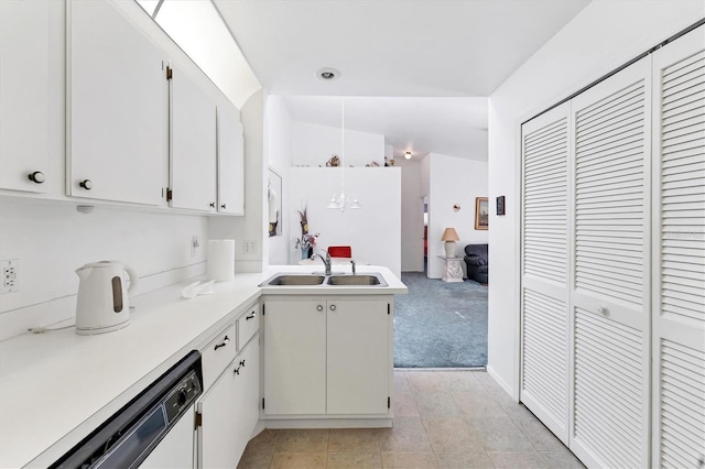 kitchen with light countertops, dishwasher, a peninsula, and white cabinetry