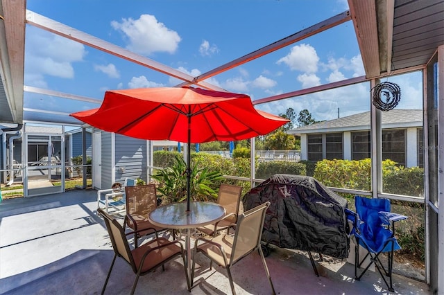 view of patio featuring glass enclosure