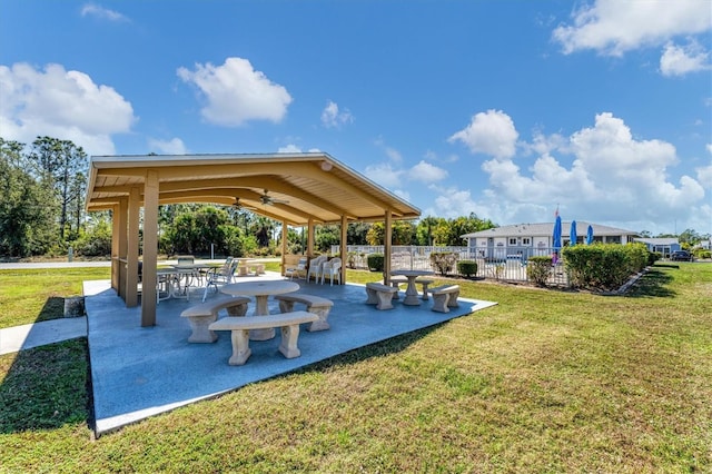 view of home's community featuring fence, a patio, and a lawn