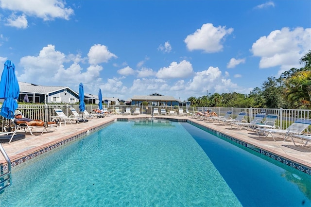 pool featuring a patio area and fence