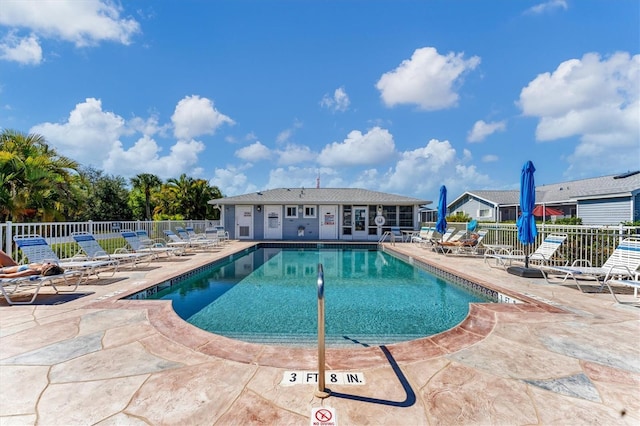 pool featuring a patio area and fence