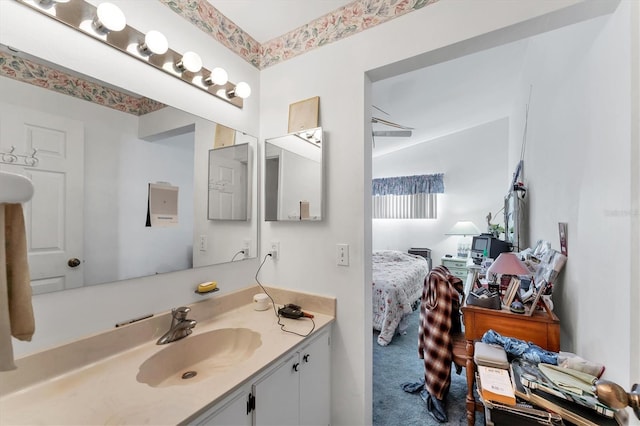 ensuite bathroom featuring connected bathroom and vanity