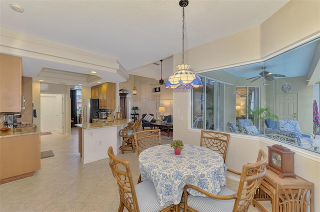 tiled dining room with ceiling fan