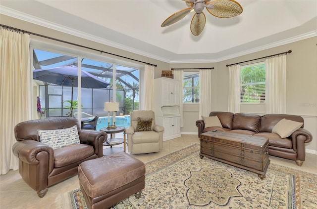 living room featuring ornamental molding, plenty of natural light, light tile patterned floors, and ceiling fan