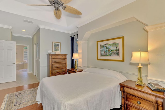 bedroom with connected bathroom, crown molding, light hardwood / wood-style flooring, and ceiling fan