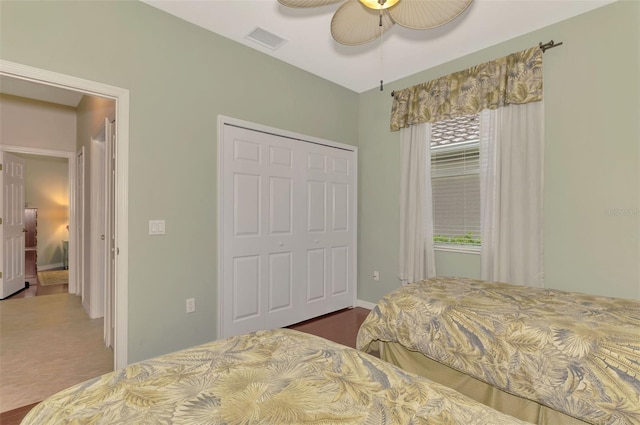 bedroom featuring ceiling fan, tile patterned floors, and a closet