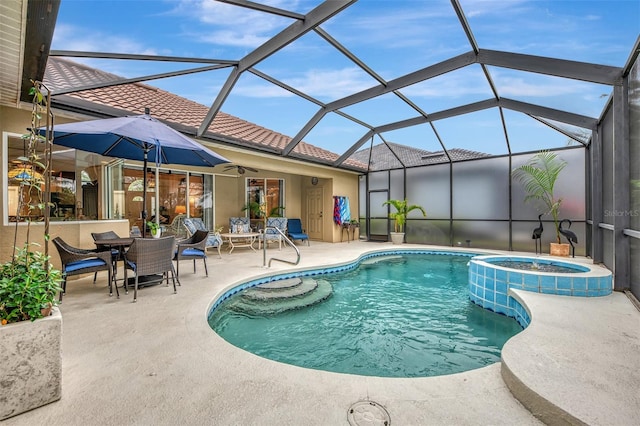 view of swimming pool featuring an in ground hot tub, a lanai, and a patio area