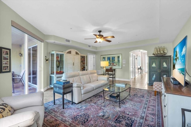 tiled living room with ceiling fan