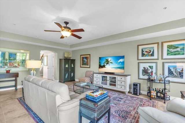 living room with ceiling fan and light tile patterned floors