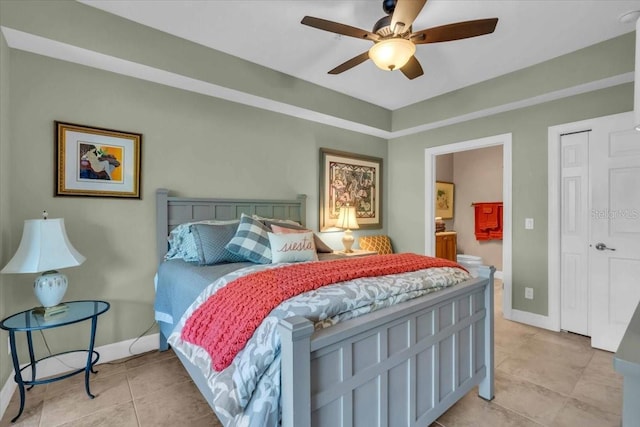 tiled bedroom with connected bathroom and ceiling fan