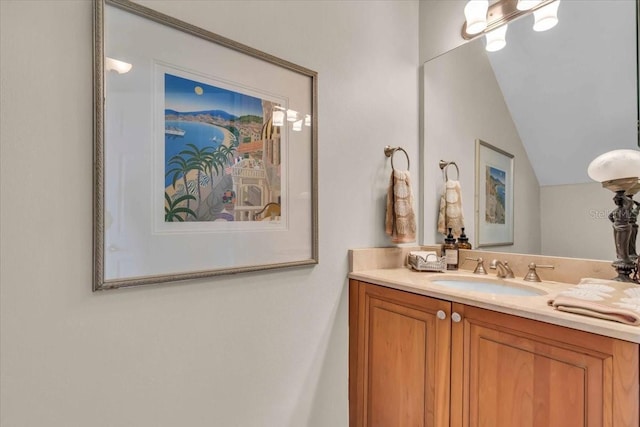 bathroom featuring vanity and vaulted ceiling