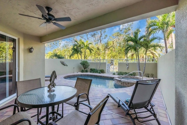 view of pool featuring a patio area, ceiling fan, and an in ground hot tub