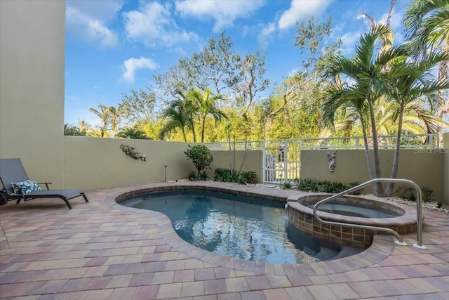 view of pool featuring an in ground hot tub and a patio area