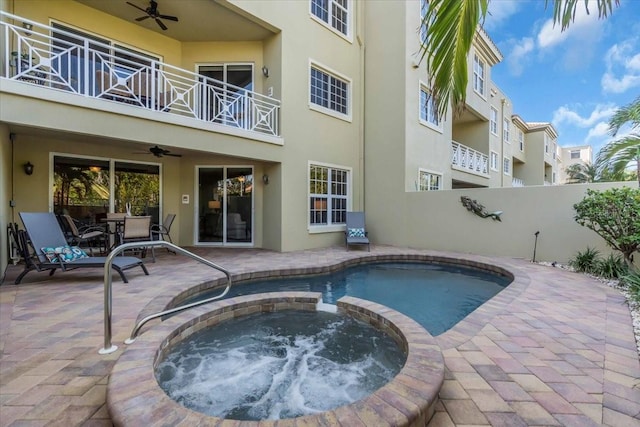 view of swimming pool featuring an in ground hot tub, ceiling fan, and a patio