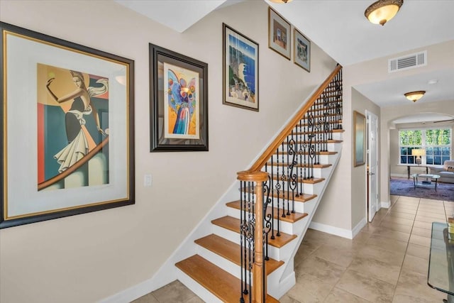 staircase featuring tile patterned floors