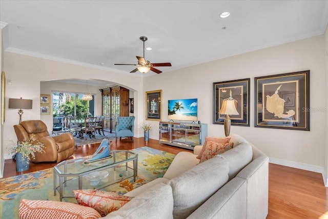 living room featuring crown molding, ceiling fan, and hardwood / wood-style floors