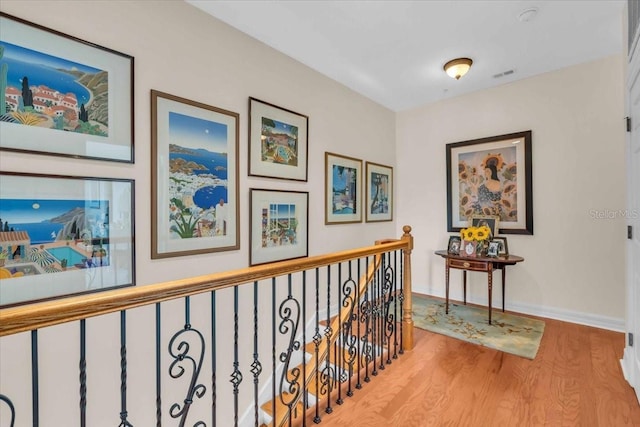 hallway with light hardwood / wood-style floors