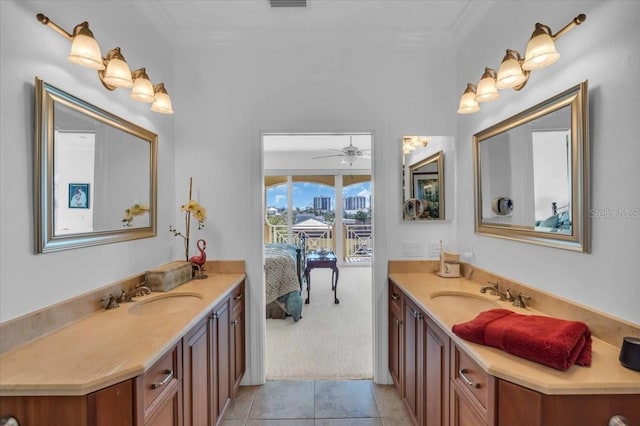 bathroom with crown molding, ceiling fan, vanity, and tile patterned flooring