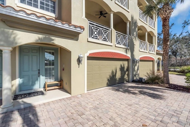 doorway to property featuring a balcony and a garage