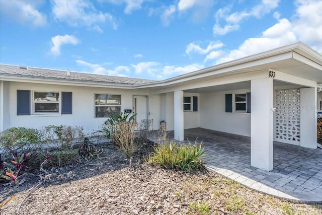 entrance to property featuring a carport