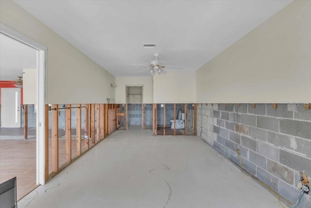 spare room featuring ceiling fan and concrete flooring