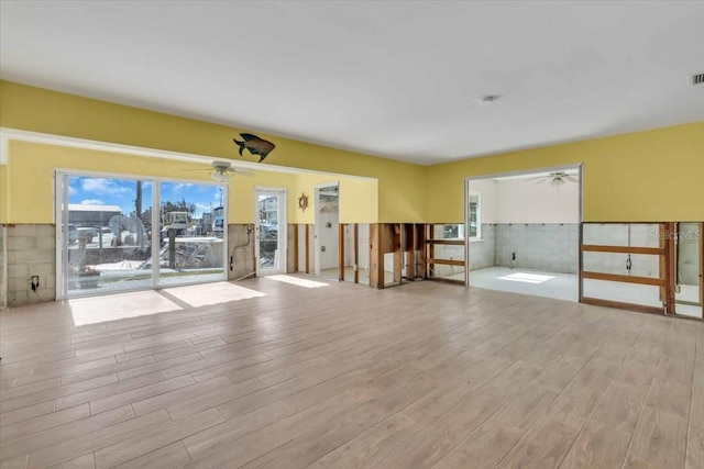 spare room featuring ceiling fan and light hardwood / wood-style floors