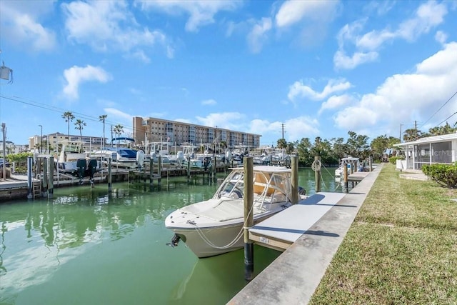 view of dock with a water view and a yard