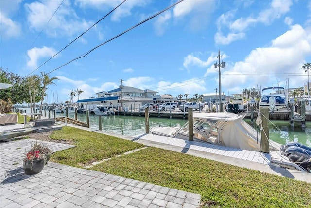 view of dock featuring a water view and a yard