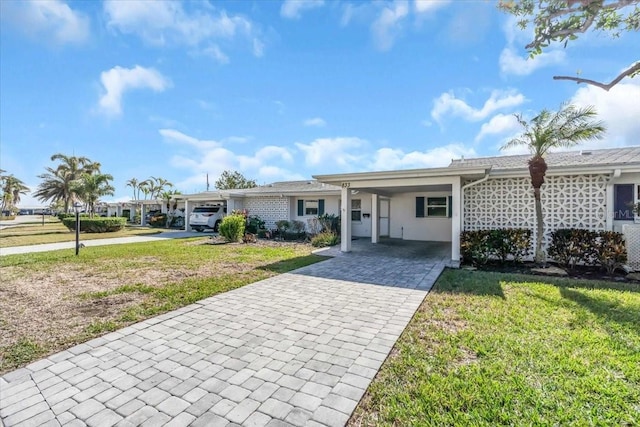 ranch-style home with a front lawn and a carport