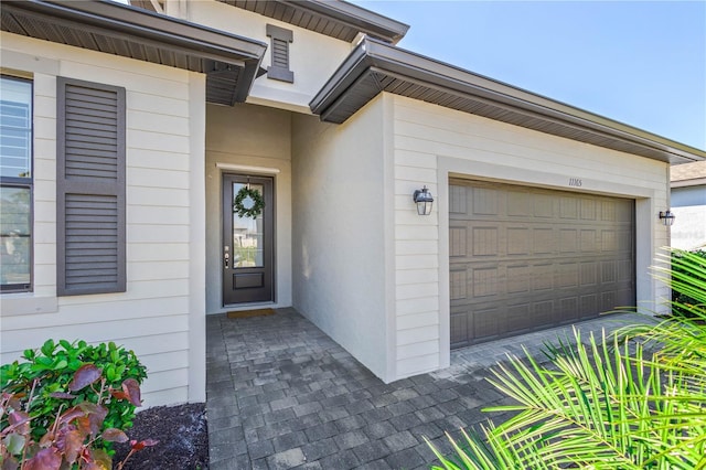 view of exterior entry with a garage